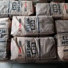 Sześć worków z napisem "BETON B25" i wagą 25kg. Gotowy do użycia kubik betonu czeka na budowę.